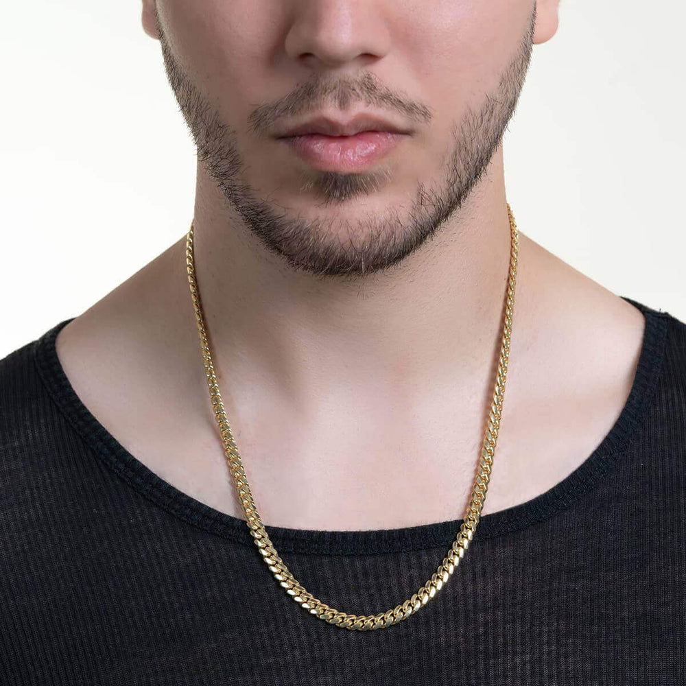 6mm solid-gold Italian Cuban link chain shown on body.