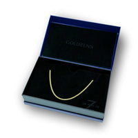 A sleek 6mm Solid Gold Cuban Link Chain with a box lock is showcased in a black velvet-lined, dark blue jewelry box, featuring "GOLDZENN" inscribed inside the lid.