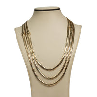 A beige jewelry bust showcases the 6mm Handmade Miami Cuban Link Chain in solid 10K/14K gold, featuring three rows of flat, interlocking links for an elegant, sophisticated layered look. Ready to ship.