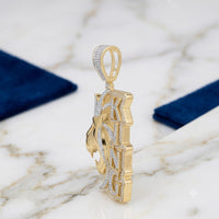 The 10K Gold Diamond Lion King Charm 2.2 CTW is a men’s pendant shaped like a lion’s head with vertical KING block letters, encrusted with small natural diamonds, shown on white marble with blue rectangular fabrics in the background.