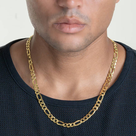 A person wearing a black shirt and the Figaro Chain 8mm - 14k Gold Bonded. The image focuses on the lower face and neck, showcasing the men's gold chain necklace.