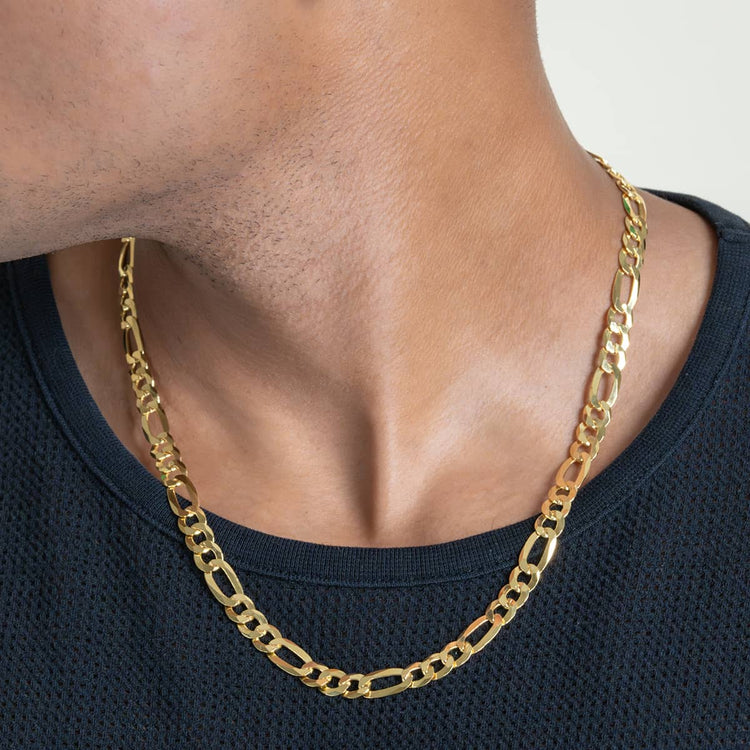 A close-up shows a person in a black textured shirt wearing the Figaro Chain 8mm - 14k Gold Bonded necklace, with focus on the neck and collar area to highlight this bold men's gold chain.