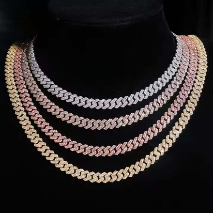 The Moissanite Cuban Link Chain - 8mm is shown on a black mannequin, featuring layered zigzag links in gold, rose gold, and 925 sterling silver tones, all encrusted with sparkling stones.