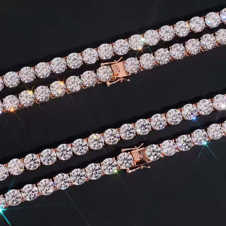 The Rose Gold Moissanite Tennis Chain Bracelet - 8mm features round, clear moissanite stones set closely on a rose gold base, arranged diagonally on a black background. The gems reflect colorful light for a stunning shimmer effect.