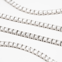 Close-up of several Tennis Chain - 925 Sterling Silver Moissanite bracelets arranged in parallel rows, each featuring sparkling round moissanite stones, set against a white background.