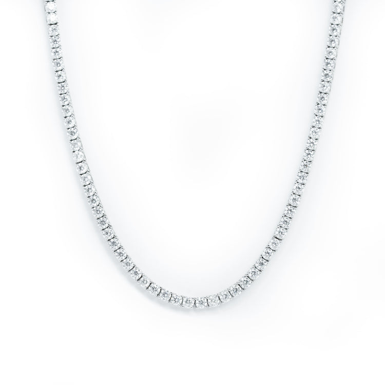 A close-up of the Tennis Chain - 925 Sterling Silver Moissanite arranged in a U-shape on a white background, showcasing small, round, closely set moissanite stones along its entire length.