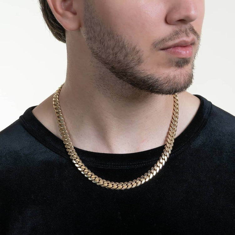 A man wearing a black shirt and a 9mm Handmade Miami Cuban Link Chain in solid 10K/14K/18K gold, shown from the shoulders up with his face partially visible.