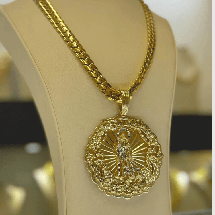 The Big Saint Lazarus Circular Pendant – 10K Solid Gold features a round, intricately detailed religious design on a jewelry bust with an ornate chain—a bold and spiritual gold necklace.