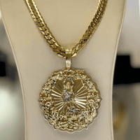 The Big Saint Lazarus Circular Pendant – 10K Solid Gold features a large, ornate religious design with detailed edges, radiating lines, and a central figure—an exquisite spiritual jewelry piece displayed on a stand.