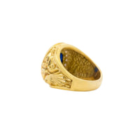 The Blue Stone Signet Ring in Solid Gold features ornate, engraved detailing on the band and is displayed from a side angle against a white background.