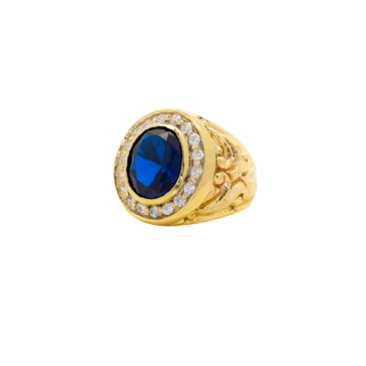 The Blue Stone Signet Ring in Solid Gold features intricate detailing, a large oval blue center stone, and a circle of small clear stones.