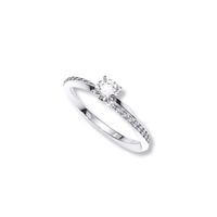 The Brilliance Eternity Lab Grown Diamond Engagement Ring is a slim silver band with a round solitaire center diamond and smaller diamonds along the top half, displayed on a plain white background.