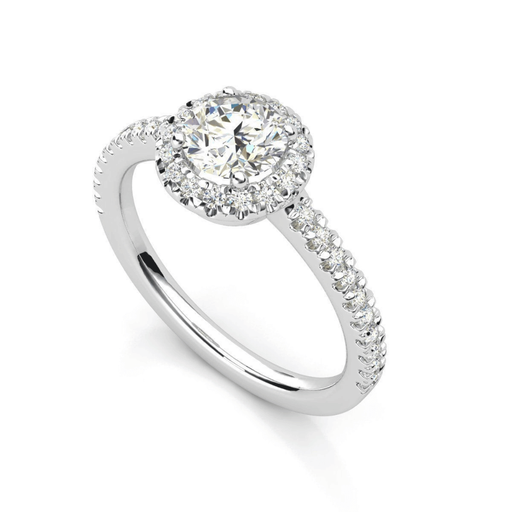 The Brilliance Halo Diamond Ring features a radiant round center diamond, a halo of smaller diamonds, and a pavé band, shown on a white background.