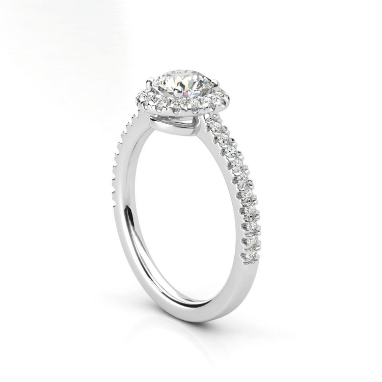 The Brilliance Halo Diamond Ring boasts a radiant round lab diamond center, encircled by a halo and set on a pavé white gold band—an elegant women’s engagement ring choice.