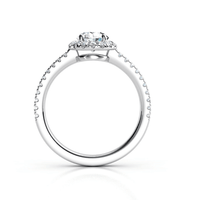 The Brilliance Halo Diamond Ring features a radiant round center diamond with pavé-set accents on the band and beneath the center stone, shown in white gold or platinum from a side view.