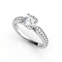 The Classic Round-Cut Lab Diamond Engagement Ring with Side Pave Details features a dazzling center stone and sparkling side accents on a split shank band, beautifully displayed against a white background.