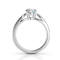 A close-up image of the Classic Round-Cut Lab Diamond Engagement Ring with side pave details, showcasing its round solitaire and plain band, viewed from the side against a white background.