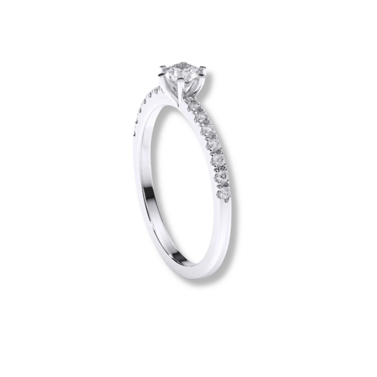 The Classic Solitaire Lab Diamond Ring with Dazzling Pavé Accents features a round lab diamond in a prong setting with sparkling pavé diamonds along the band, shown elegantly against a plain white background.