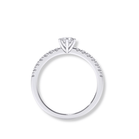 The Classic Solitaire Lab Diamond Ring with Dazzling Pavé Accents features a round lab-grown diamond in a prong setting, set in white gold or platinum, with sparkling pavé accent diamonds on the band, displayed against a white background.