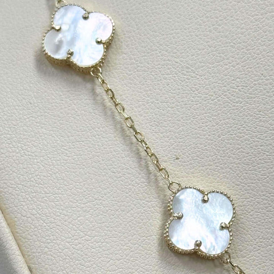 White Four Leaf Clover Necklace - 14k Yellow Gold Elegant 14k yellow gold necklace with a luminous white four leaf clover pendant. A symbol of luck and delicate beauty. Shop the White Clover Necklace today!