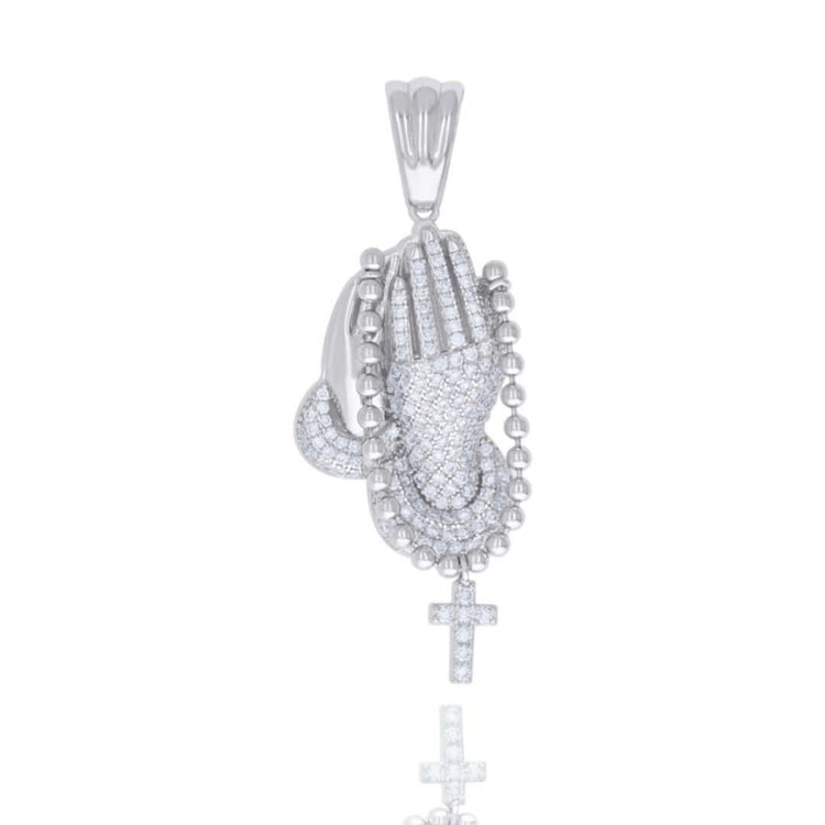 The Cross Praying Hands Symbol Religious Charm Pendant, crafted in 925 sterling silver and adorned with sparkling VVS moissanite stones, holds a beaded rosary with a cross and is shown on a white background with a subtle reflection.