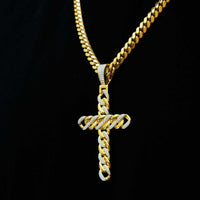 The Lab Diamond Cuban Link Cross Pendant, featuring a matching gold chain and VS Clarity lab-grown diamonds in a striking Cuban link design, sparkles brilliantly against a black background.
