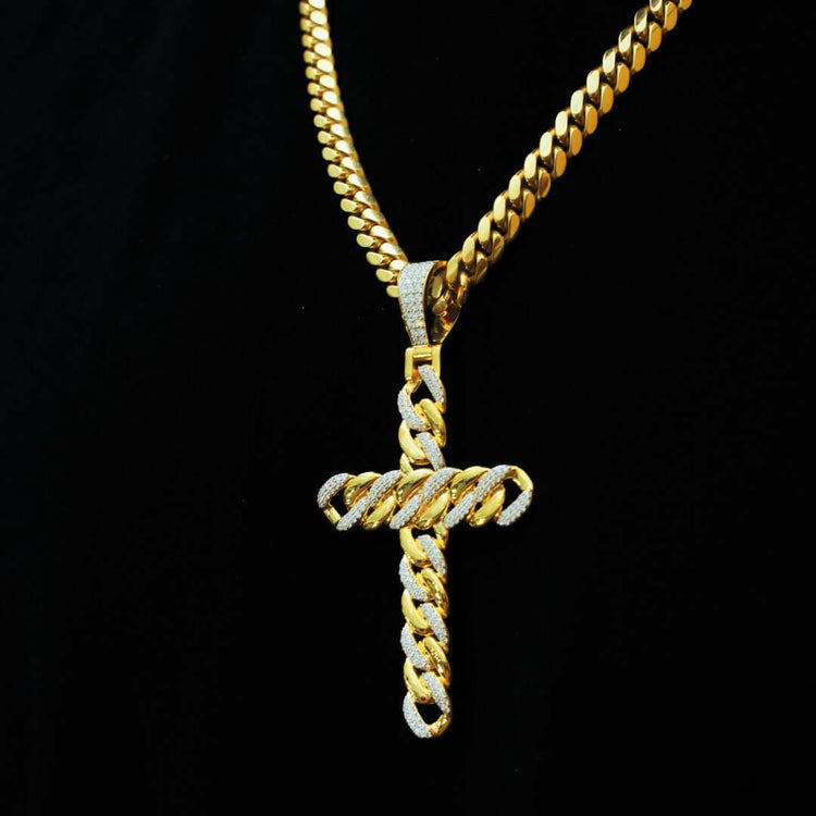The Lab Diamond Cuban Link Cross Pendant, featuring a matching gold chain and VS Clarity lab-grown diamonds in a striking Cuban link design, sparkles brilliantly against a black background.