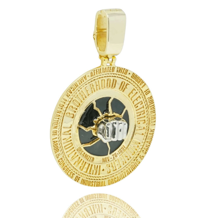 The Custom 10K Electrician Brotherhood Pendant in yellow and white gold features raised International Brotherhood of Electrical Workers text and a black and silver clenched fist gripping lightning bolts at the center.