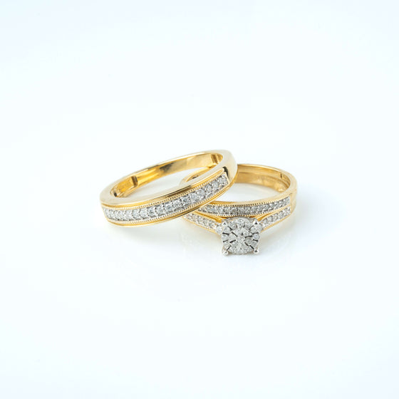 3/8 CTW 10k yellow gold wedding trio set with diamond engagement ring and matching wedding bands.