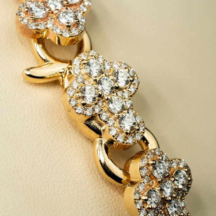 Close-up of the Diamond Chain - Cross Shaped 10K 22", showcasing cross-shaped links adorned with lab-grown diamonds, displayed on a light beige background.
