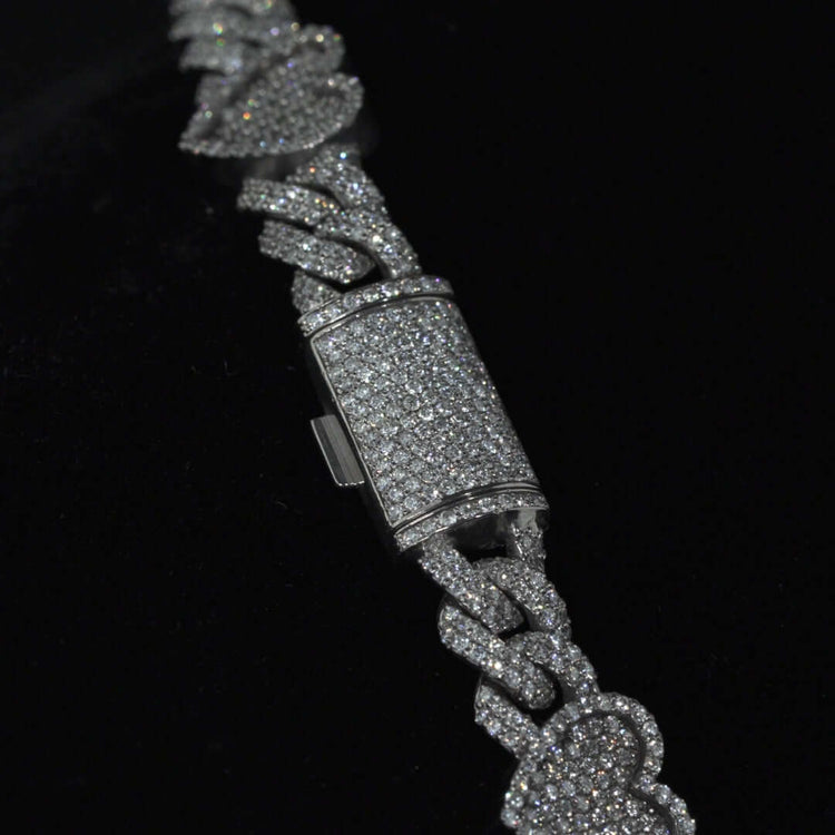 A close-up of the Diamond Chain - Heart Shaped 10k White Gold bracelet, featuring heart-shaped links adorned with sparkling natural diamonds, set against a black background.