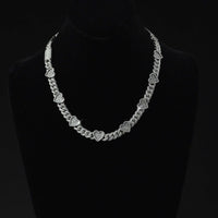 The Diamond Chain - Heart Shaped 10k White Gold features small, sparkling heart charms on a white gold chain, elegantly displayed on a black velvet bust with a plain black background.