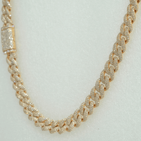 The Diamond Cuban Link Chain – 11mm is crafted in 10k solid gold, featuring a textured, lab-grown diamond-encrusted design, shown against a light neutral background.