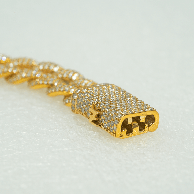 Close-up of the Diamond Cuban Link Chain – 11mm, crafted in 10k solid gold and encrusted with sparkling lab-grown diamonds, featuring a box clasp, displayed on a light textured surface.