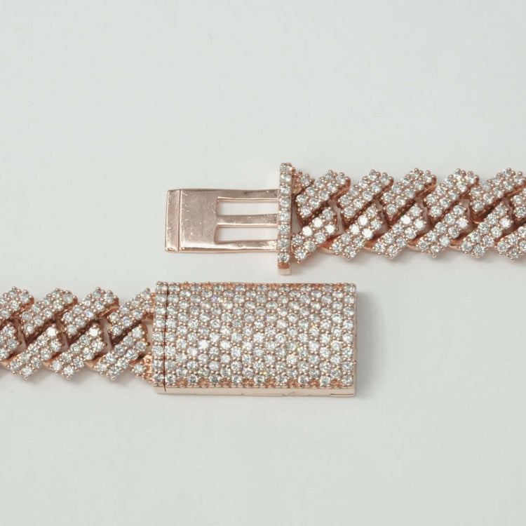 A close-up of the Diamond Cuban Link Chain - 15mm in rose gold, encrusted with small sparkling diamonds and featuring a rectangular clasp, displayed on a plain light background.
