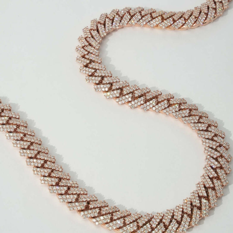 The Diamond Cuban Link Chain - 15mm features a bold, classic design with shimmering diamonds set in rose gold, offering an elegant and modern twist on the traditional Cuban link chain.