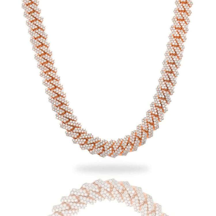 The Diamond Cuban Link Chain – 8mm-17.5mm Solid Rose Gold features a luxurious twisted pattern of rose gold and sparkling diamonds, beautifully showcased against a white background with a soft reflection beneath.