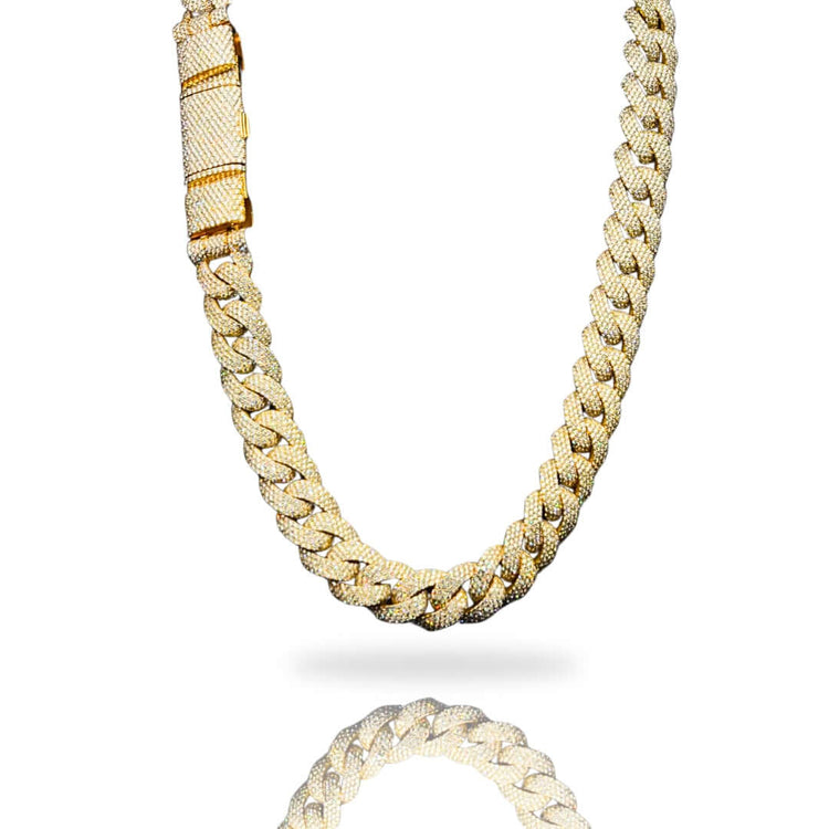 The Diamond Cuban Link Chain - Semi Solid - 16mm, crafted in 10k gold with a diamond-encrusted clasp featuring lab-grown diamonds, is shown against a white background with a subtle reflection below.