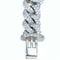 A close-up of the Diamond Heart Cuban Link Bracelet showing its interwoven links adorned with small diamonds and finished with a silver clasp.