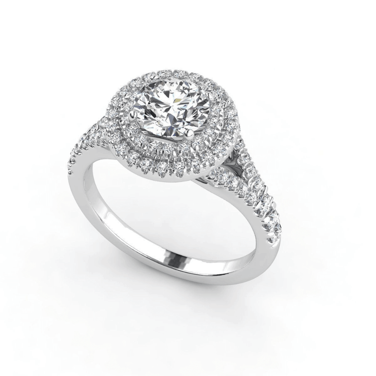 The Double Halo Round Cut Lab Diamond Engagement Ring in white gold features a round lab-grown center stone, split shank band, and sparkling accents—a timeless choice for women's engagements.
