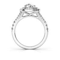 The Double Halo Round Cut Lab Diamond Engagement Ring features a round lab-grown diamond center, surrounded by two halos of smaller diamonds and a decorative gallery beneath the main stone, set in white gold or platinum.
