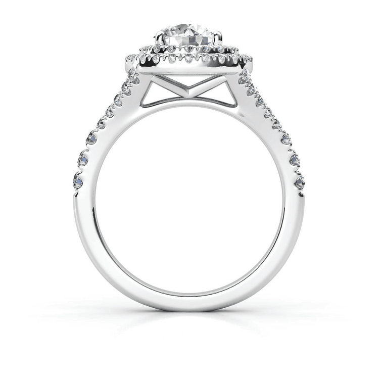 The Double Halo Round Cut Lab Diamond Engagement Ring features a round lab-grown diamond center, surrounded by two halos of smaller diamonds and a decorative gallery beneath the main stone, set in white gold or platinum.