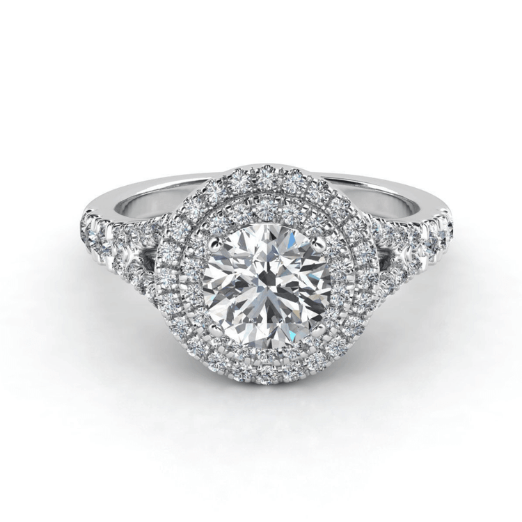 The Double Halo Round Cut Lab Diamond Engagement Ring in white gold showcases a large round lab-grown diamond, two sparkling halos of smaller diamonds, and extra diamonds on the band for a breathtaking look.