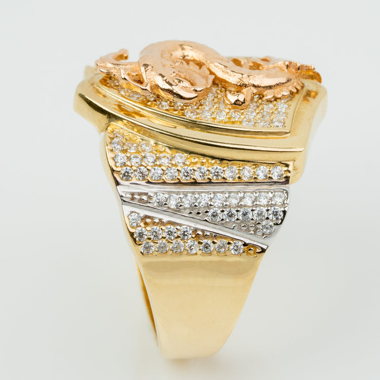 The Dragon Shield Ring - 10k Solid Gold features a raised dragon design, pavé-set gemstones on the face and band, and two silver-toned accent lines with extra stones—making it a bold statement piece for men.