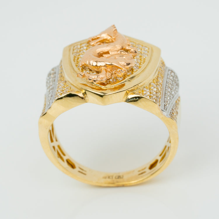 The Dragon Shield Ring – 10K Solid Gold features a raised dragon on a shield-shaped top, accented with clear stones and intricate patterns. Polished gold and rose gold tones make this men’s ring a bold statement piece.