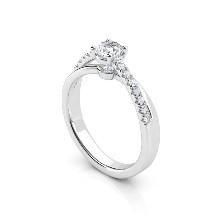 The Elegant Twist Solitaire Engagement Ring features a lab-grown round diamond in a white gold prong setting, accented with smaller diamonds along one side of the band.