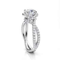 The Elegant Twisted Halo Lab Diamond Ring features a cushion-cut center stone set above a twisted band with pavé diamonds, displayed on a white background.