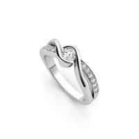 The Engagement Twist Ring - Lab Diamond is a silver ring with a central round lab-grown diamond, featuring a twisted band accented by smaller diamonds set along one side.