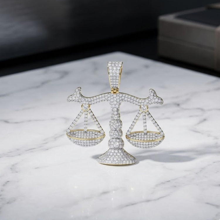 A 925 Sterling Silver Mens Moissanite Justice Pendant rests on a marble surface, glittering under soft light—a striking showcase of zodiac sign jewelry.