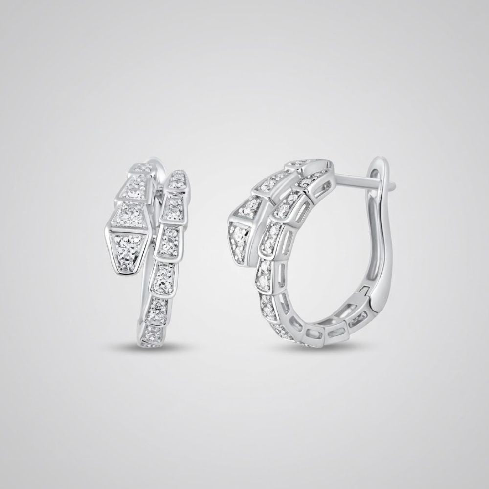 The 14k White Gold Snake Diamond Hoop Earrings 1/3CTW showcase geometric segments with sparkling natural diamonds, set in hoops displayed on a plain light gray background.